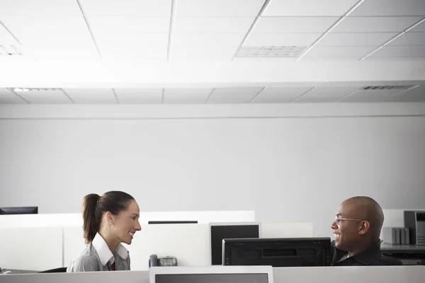 Office workers sitting face to face — Stock Photo, Image