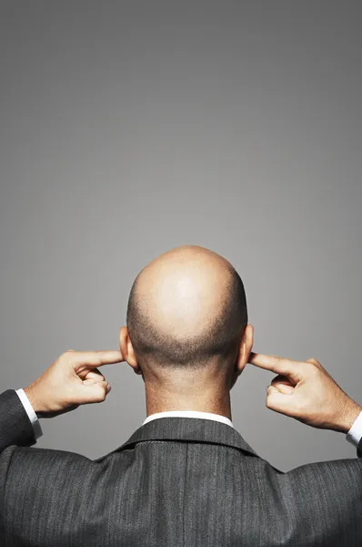 Businessman Plugging His Ears — Stock Photo, Image