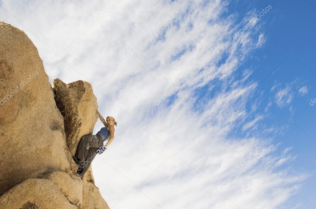 Woman Free Climbing on Rocks