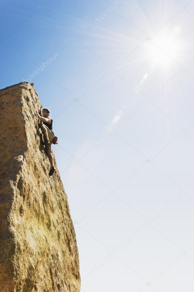 Woman Free Climbing on Cliff