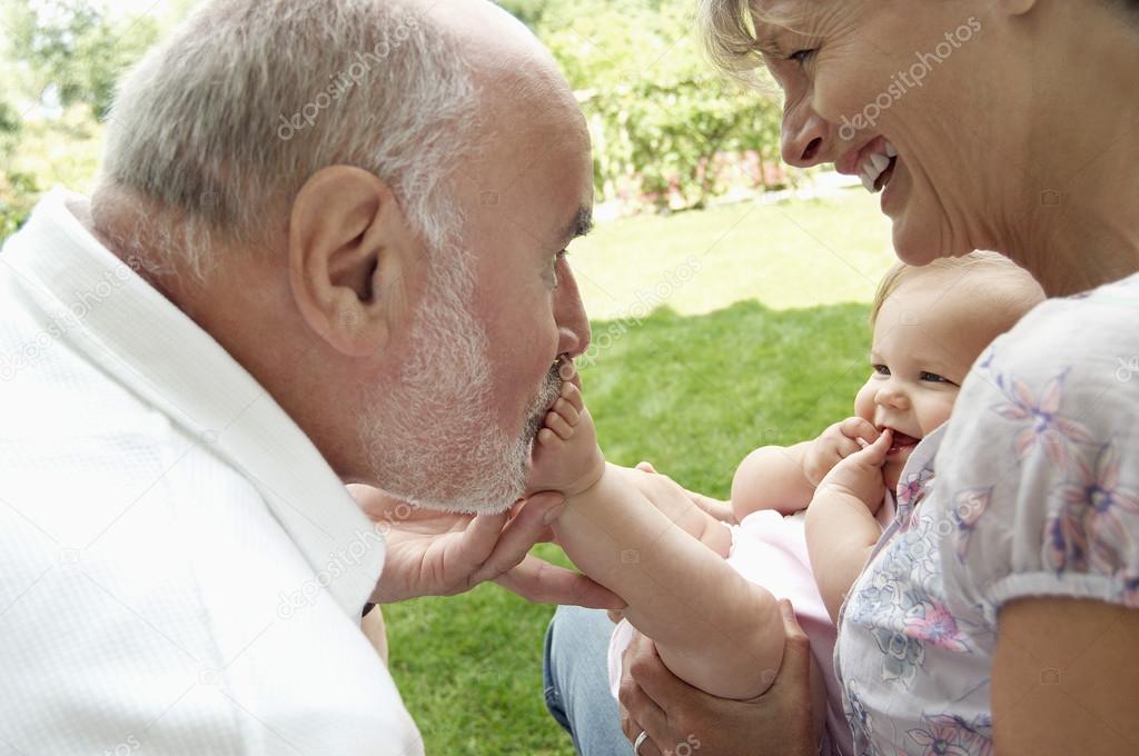 Grandparents playing with granddaughter