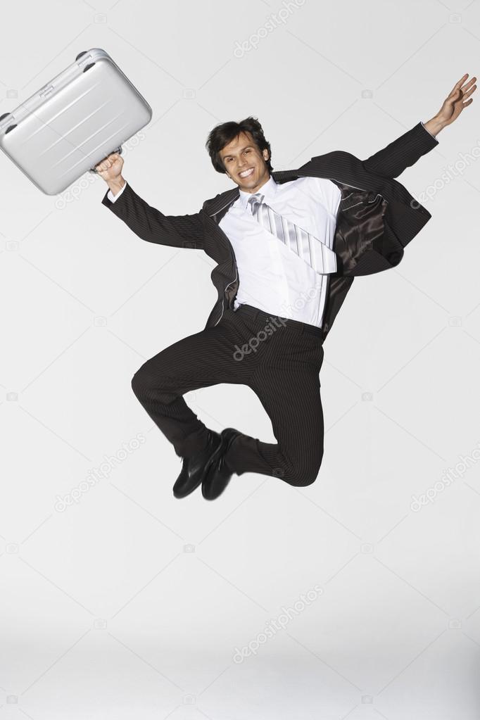 Businessman jumping clicking heels