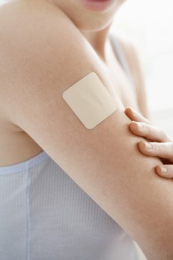 Nicotine patch on arm clipart