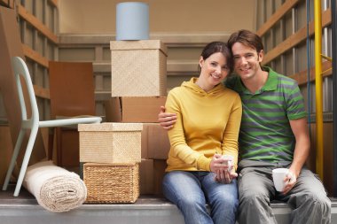 Couple Sitting in Back of Moving Van clipart