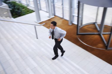 Businessman Running up Stairs clipart