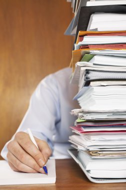 Man behind stack of paperwork clipart