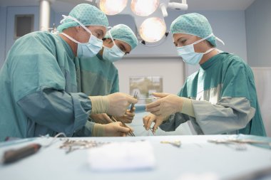three surgeons at work clipart