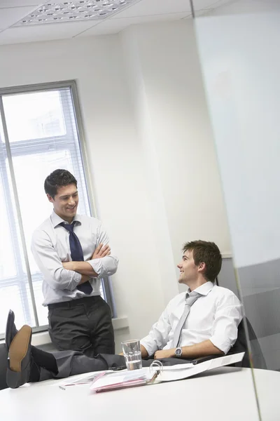 Happy businessmen relaxing and talking — Stock Photo, Image