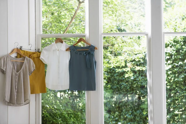 Blouses and skirt on hangers — Stock Photo, Image