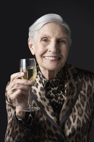 Senior woman with glass of wine — Stock Photo, Image