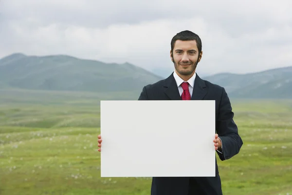 Businessmen holding blank sign — Stock Photo, Image