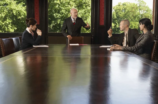 Businesspeople meeting around boardroom table — Stock Photo, Image