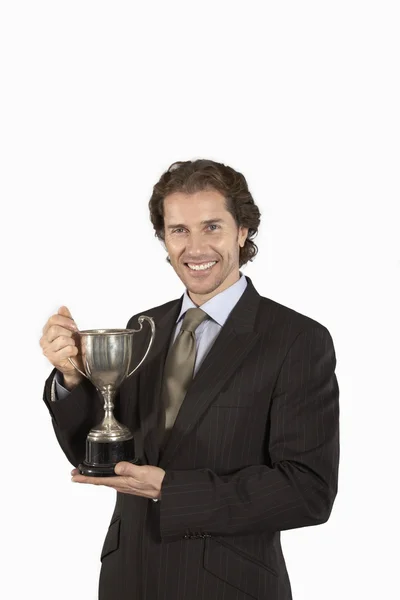 Businessman holding trophy — Stock Photo, Image