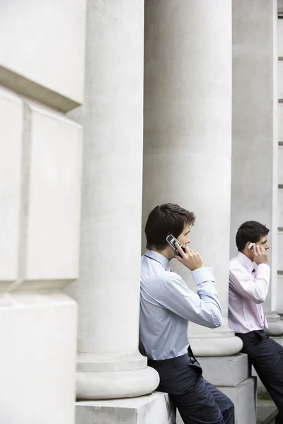 Businessmen on cell phones — Stock Photo, Image