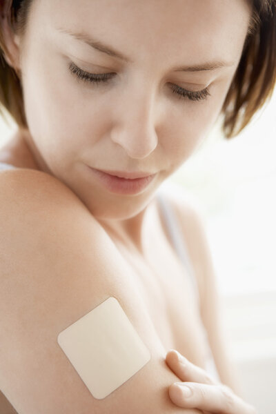 Woman looking at nicotine patch