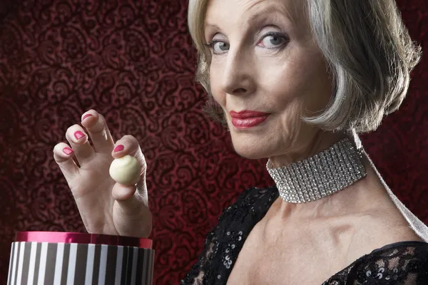 Senior Woman with candy — Stock Photo, Image