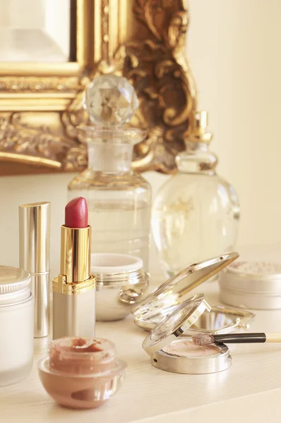 Table With Cosmetics and Wall Mirror — Stock Photo, Image