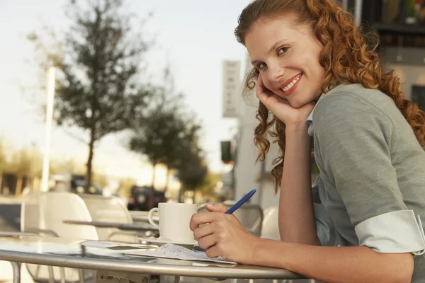 Женщина в кафе на тротуаре — стоковое фото