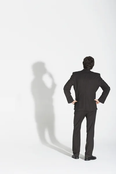 Businessman arguing with own shadow — Stock Photo, Image