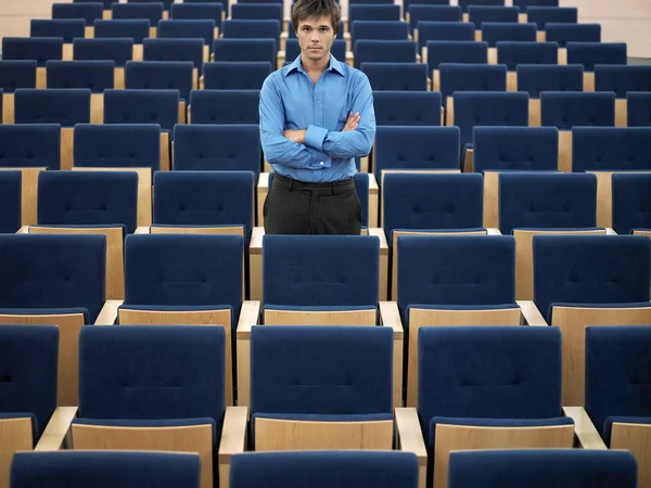 Businessman standing in Auditorium — Stock Photo, Image