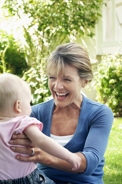 Grandmother and granddaughter in garden 
