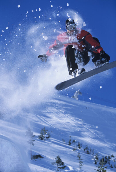 Snowboarder mid-air above ski
