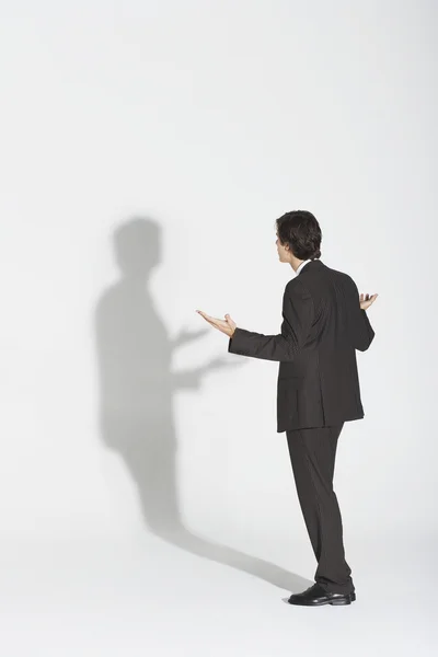 Businessman arguing with own shadow — Stock Photo, Image