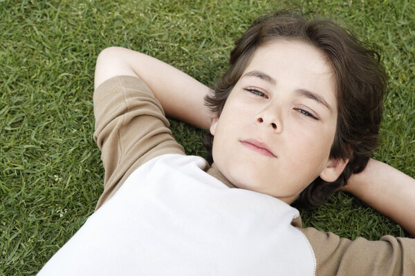 Boy lying in grass