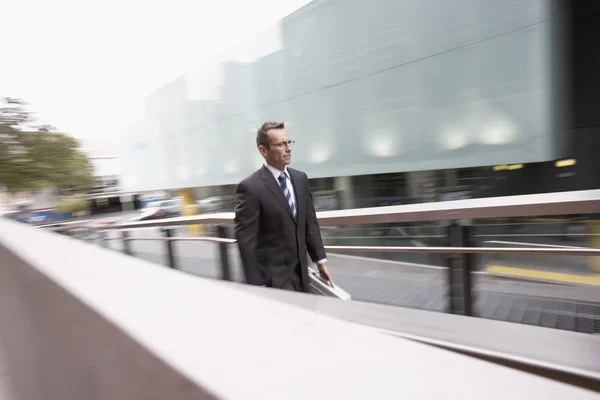 Businessman walking up outdoor ramp — Stock Photo, Image