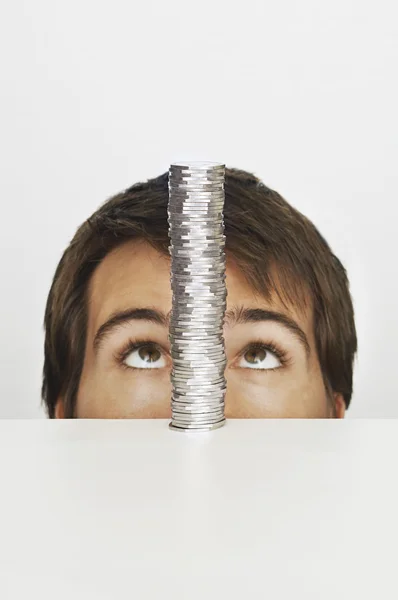 Man looking at stack of coins — Stock Photo, Image