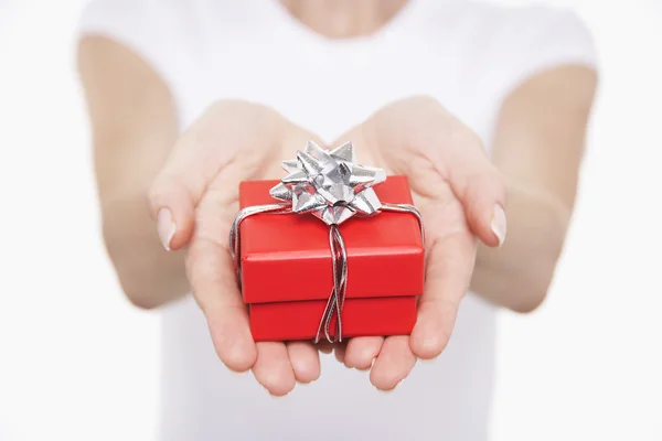 Woman offering small gift — Stock Photo, Image