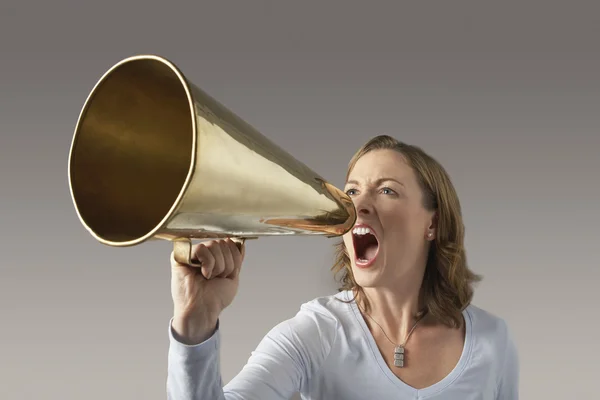 Angry woman shouting through megaphone — Stock Photo, Image