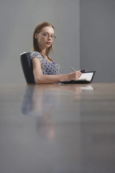 Businesswoman  writing in appointment calendar Stock Photo
