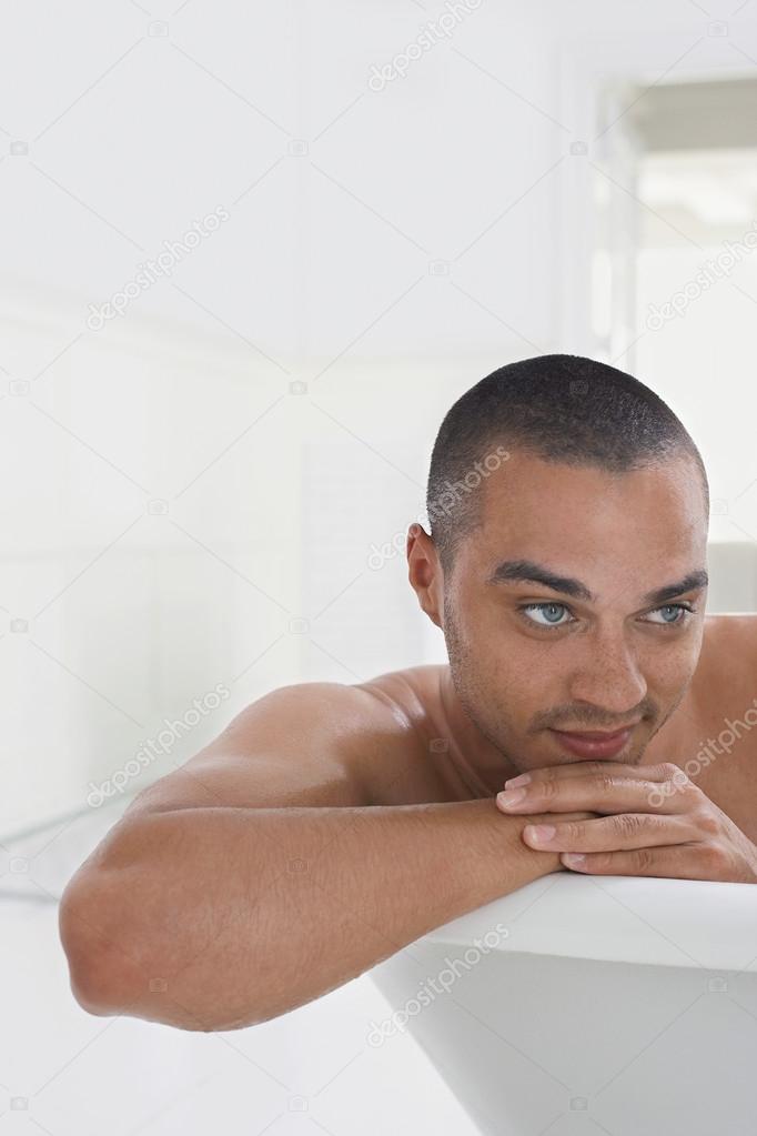 Man relaxing in bathtub