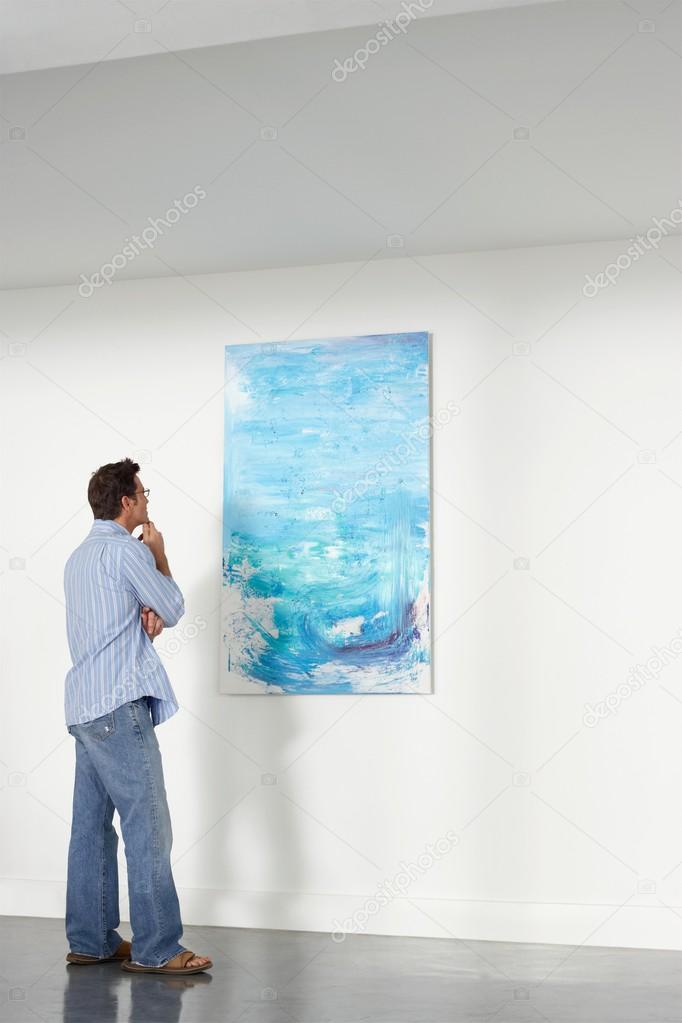 Man observing in art gallery