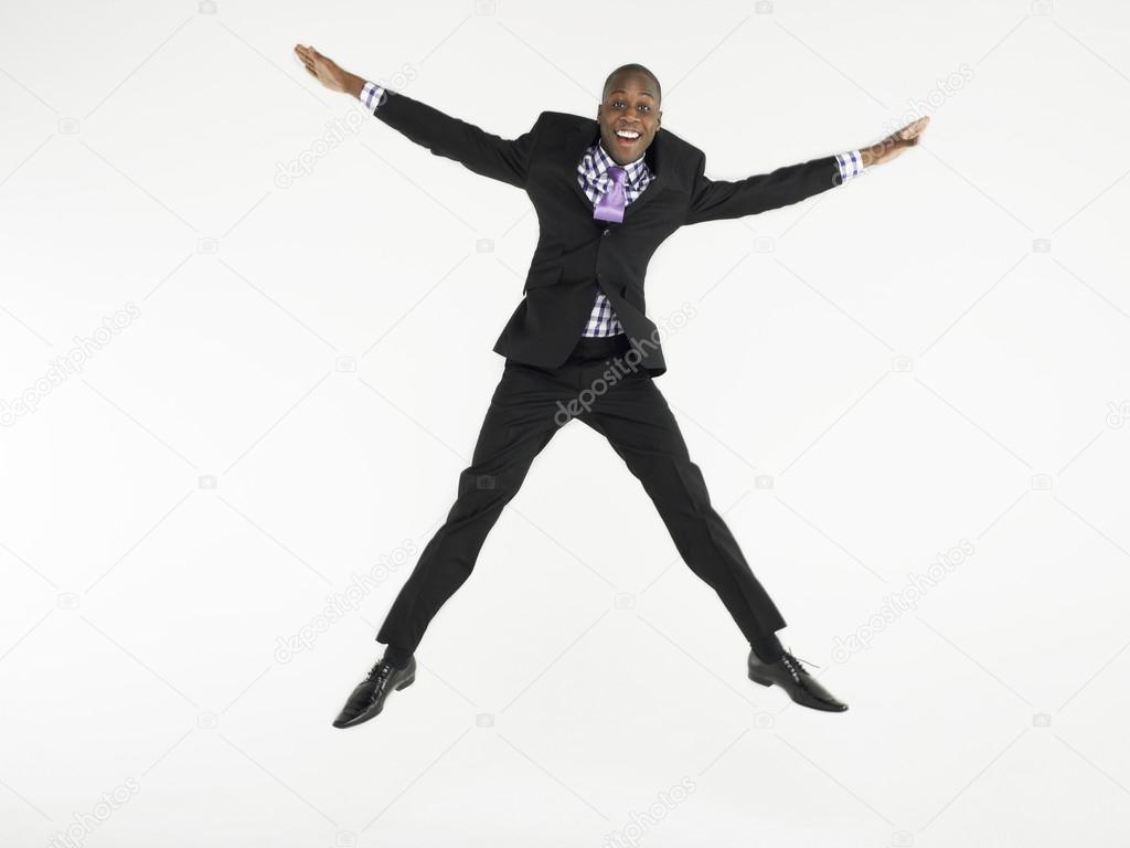 Man in suit jumping in star shape
