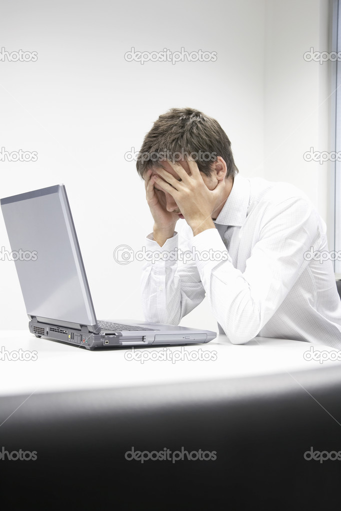 Stressed businessman with laptop