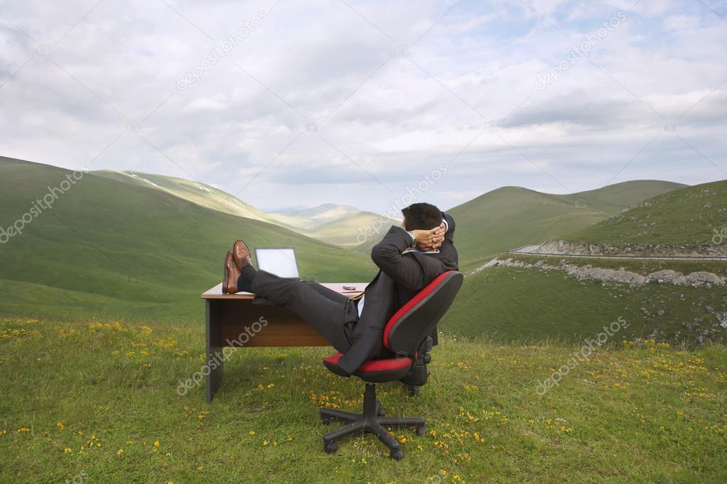Businessman relaxing in mountain