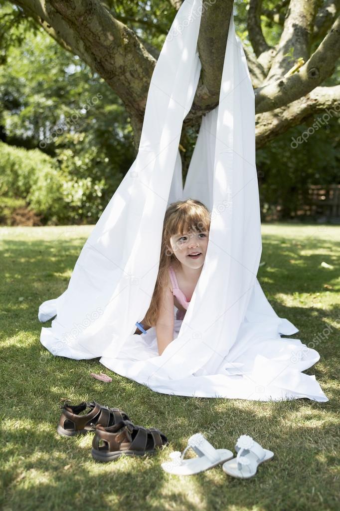 girl peeking  out of tent 