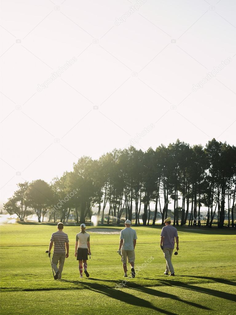 Golfers walking on golf course