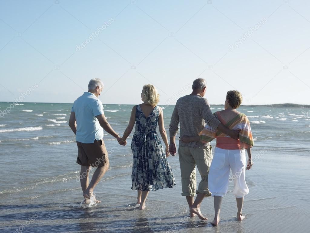 Couples walking on tropical beach
