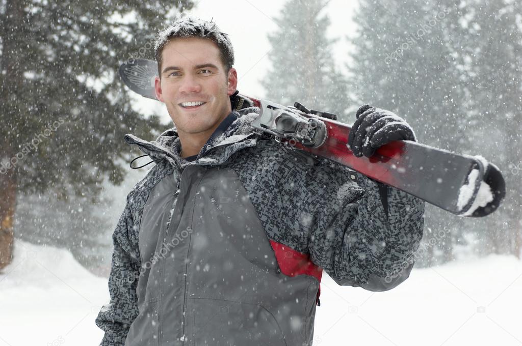 Man holding skis