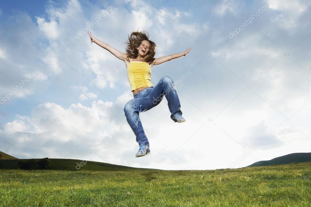 Woman jumping in meadow