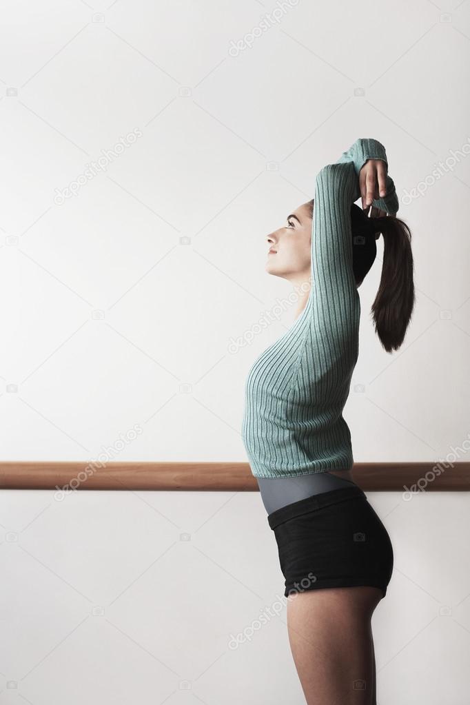 Ballet Dancer with arms overhead at bar