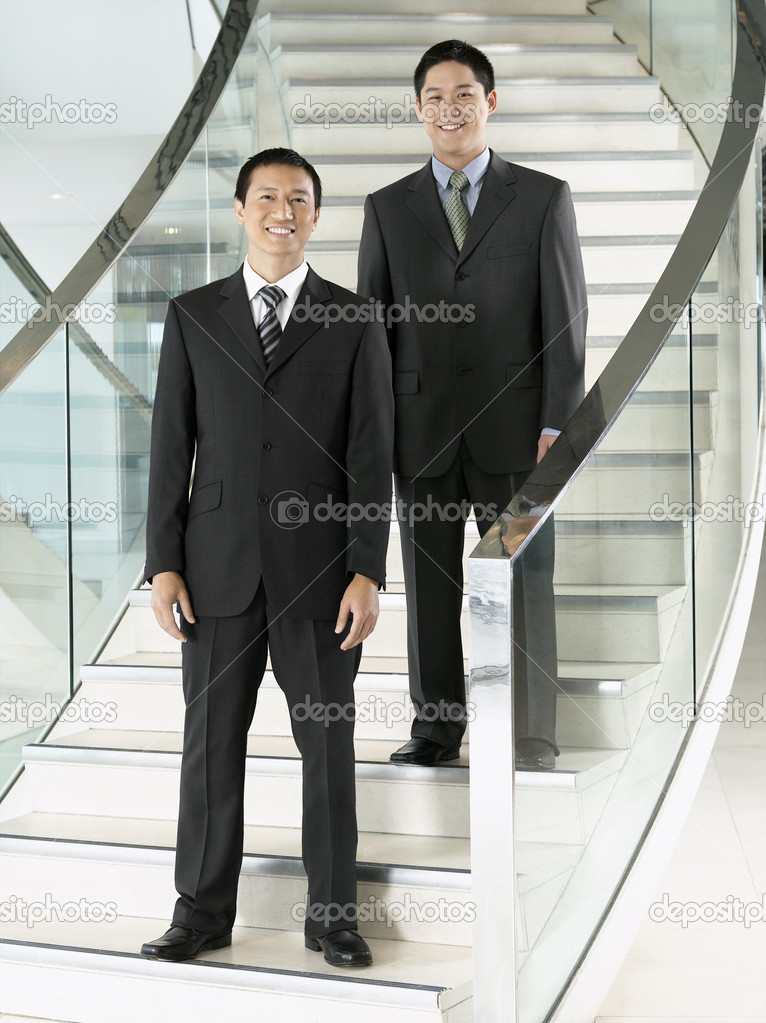 Confident Businessmen standing on staircase