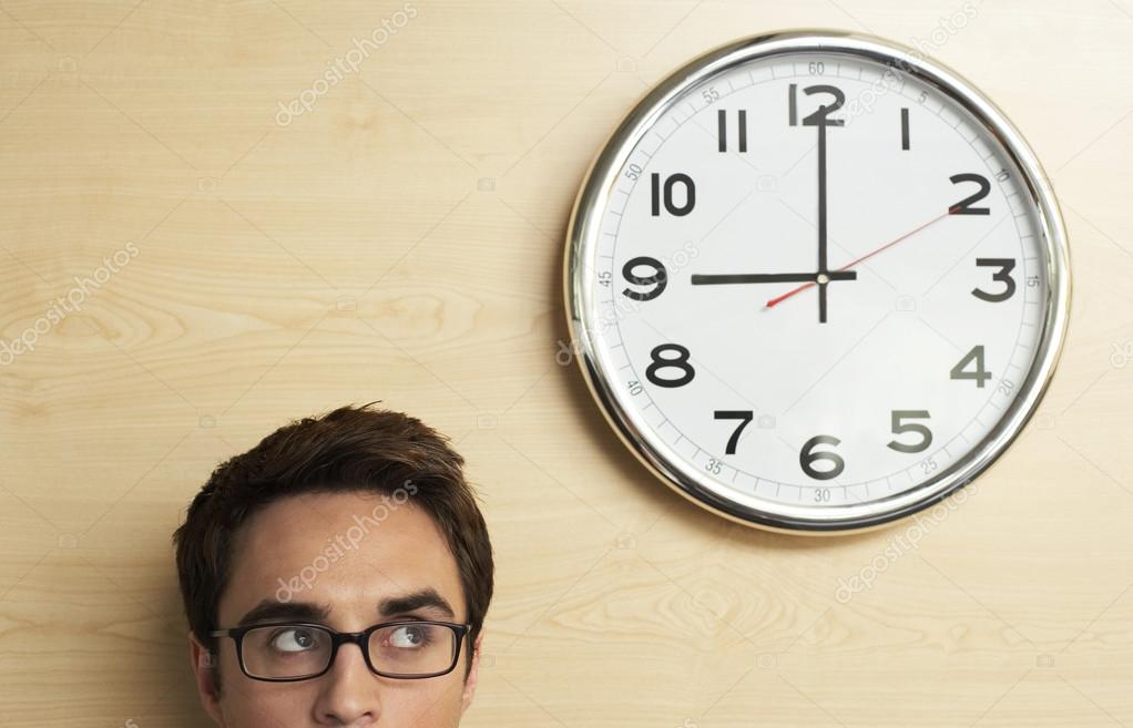 Businessman looking to clock