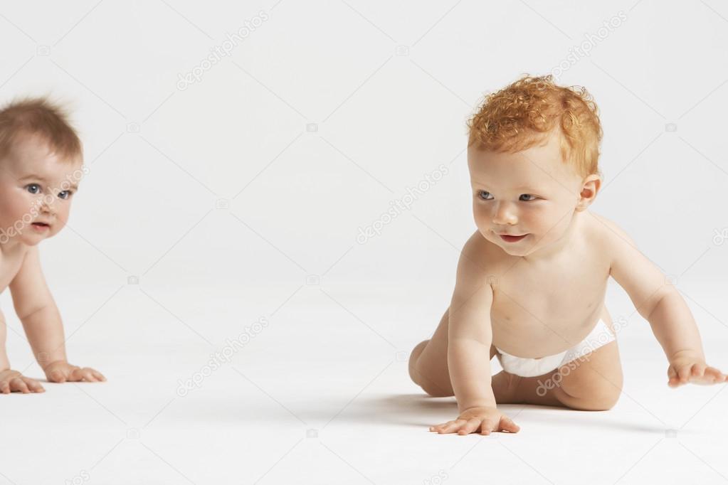Crawling baby pursuing another