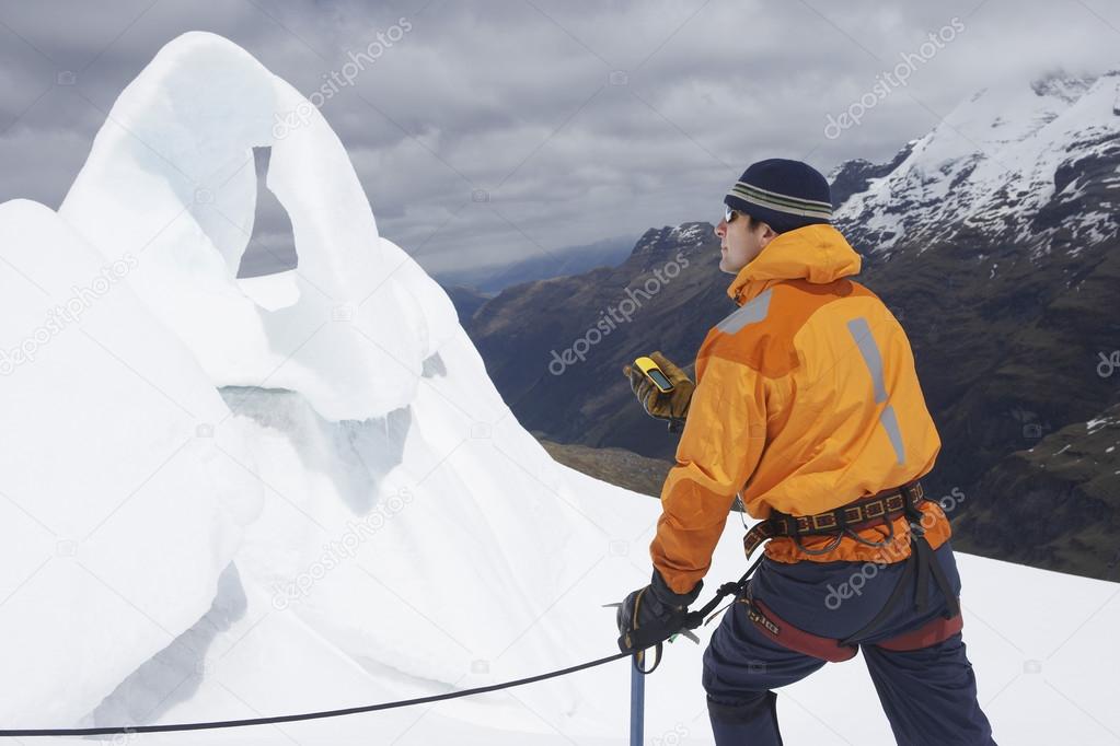 Mountain climber holding compass