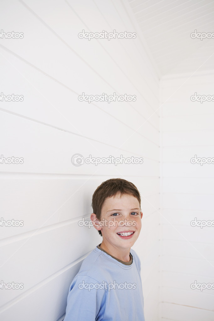 Boy Standing Against Wall