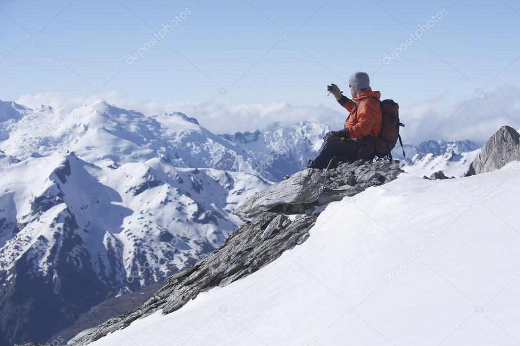 Mountain climber taking picture